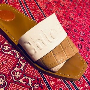 Chloe “Woody” flat leather sandals.